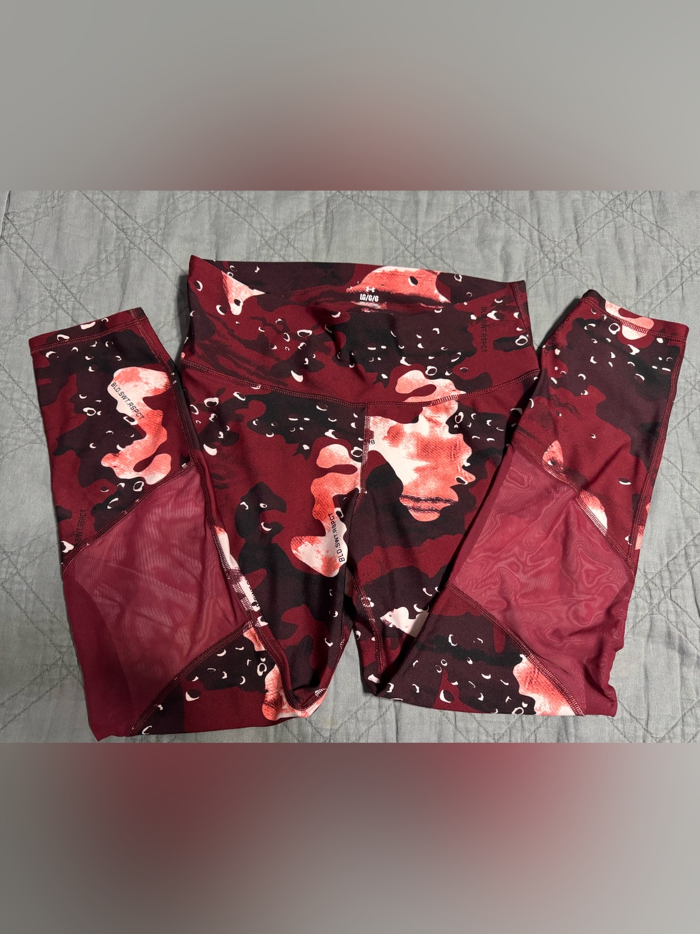 Under Armour Women's Maroon and Black Camo Leggings with Mesh near calves.